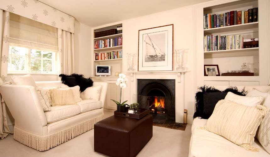 Sofas around fire place in winter rooms